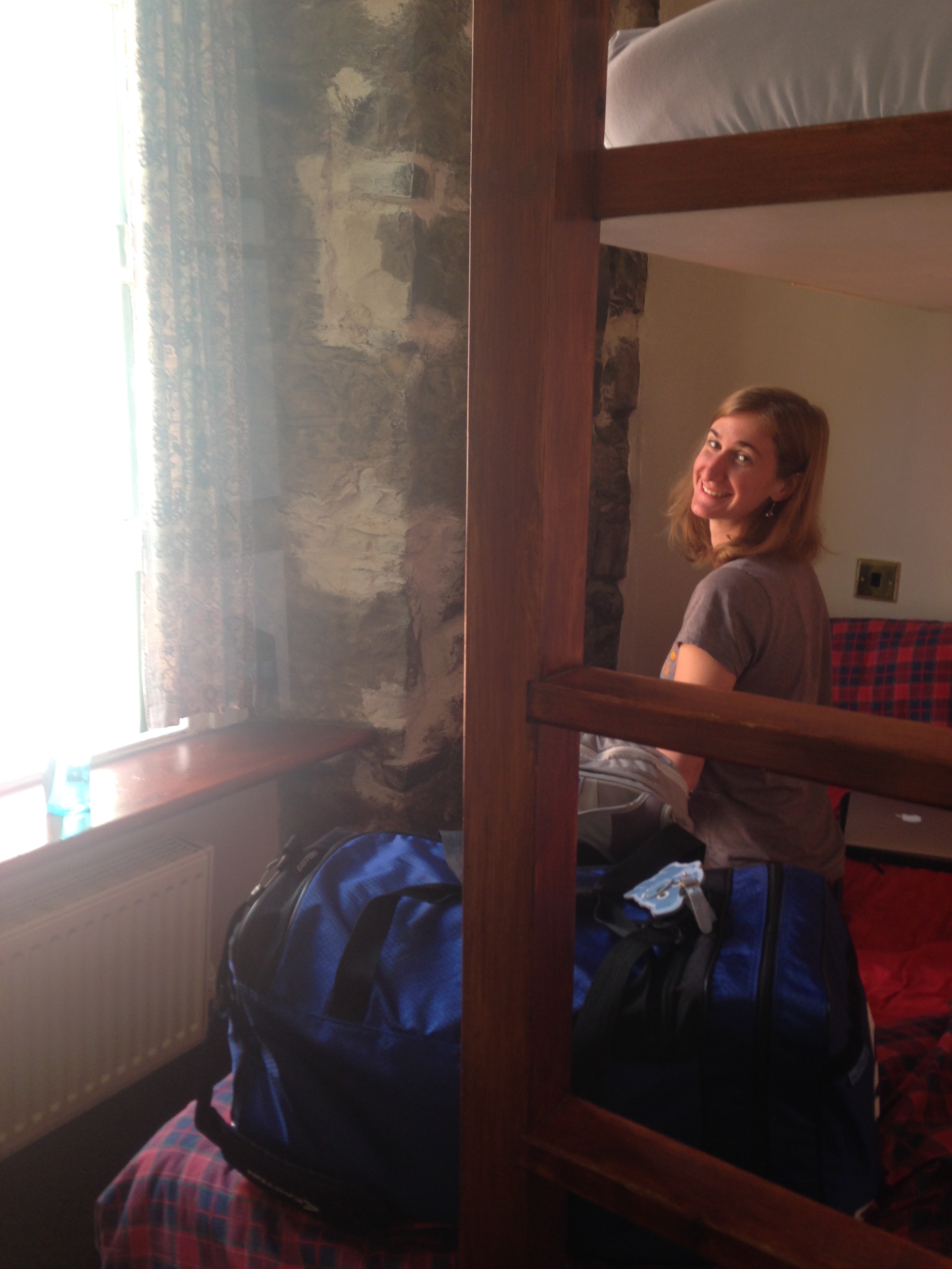 A picture of my friend Kate sitting on our bunk bed.