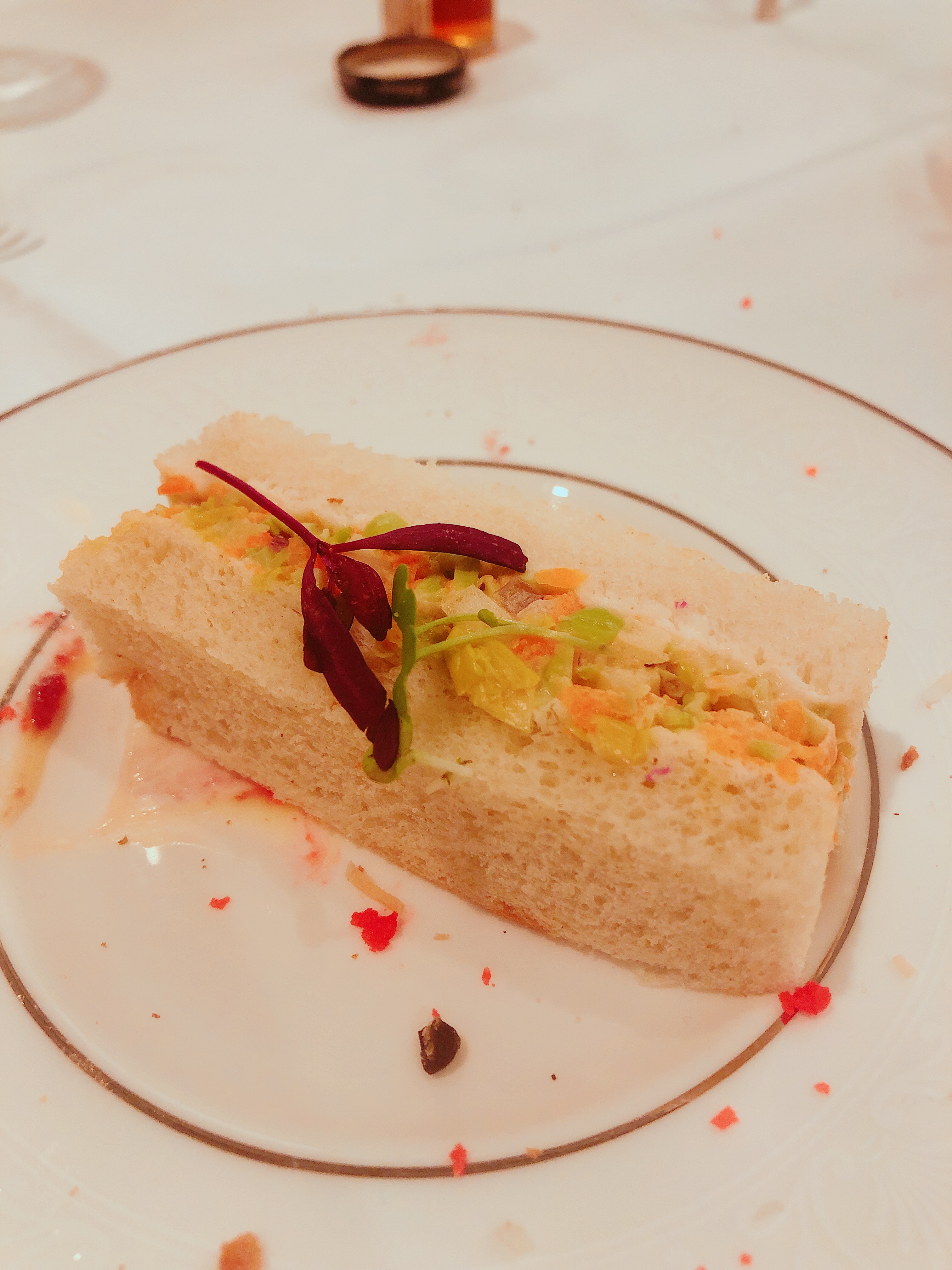 Apple and Edamame Sandwich; a small rectangular sandwich stuffed with pieces of green apple, edamame and chives.